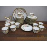 A late 19th/early 20th century Limoges porcelain tea set, hand coloured floral decoration with