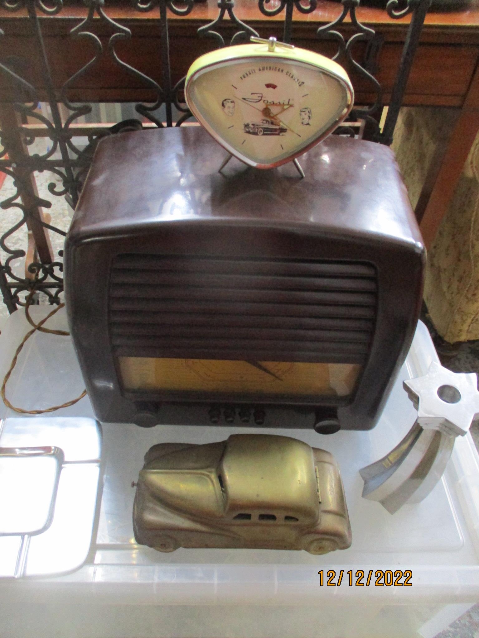A General Electric Company (GEC) Bakelite cased radio, a Fossil American classic alarm clock,