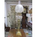 A Victorian gilt brass Corinthian column Duplex oil lamp by Hinks, with cut glass reservoir, and