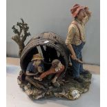 A Capodimonte figure group, signed La Buzla A/F of a gentleman and two children in a barrel,