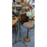 A Victorian wrought iron oil standard lamp, and a mahogany wine table Location:
