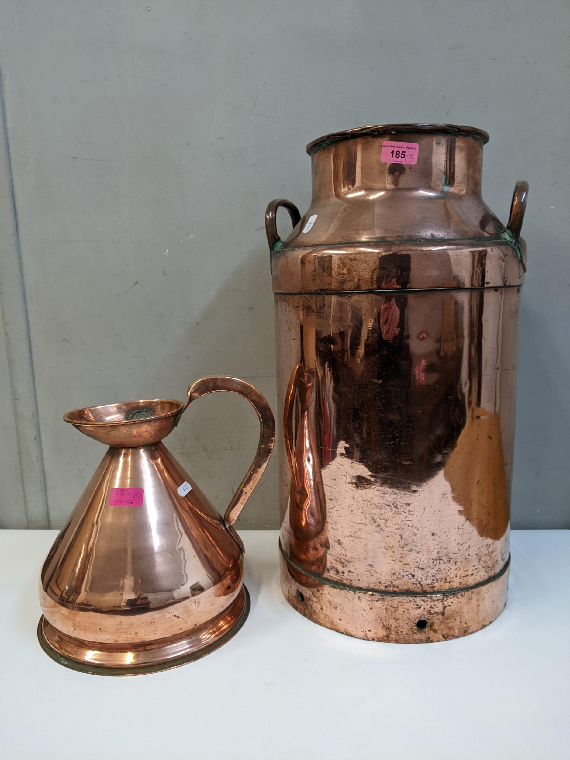 A copper plated mil churn, 57cm h and a copper measuring jug Location: G
