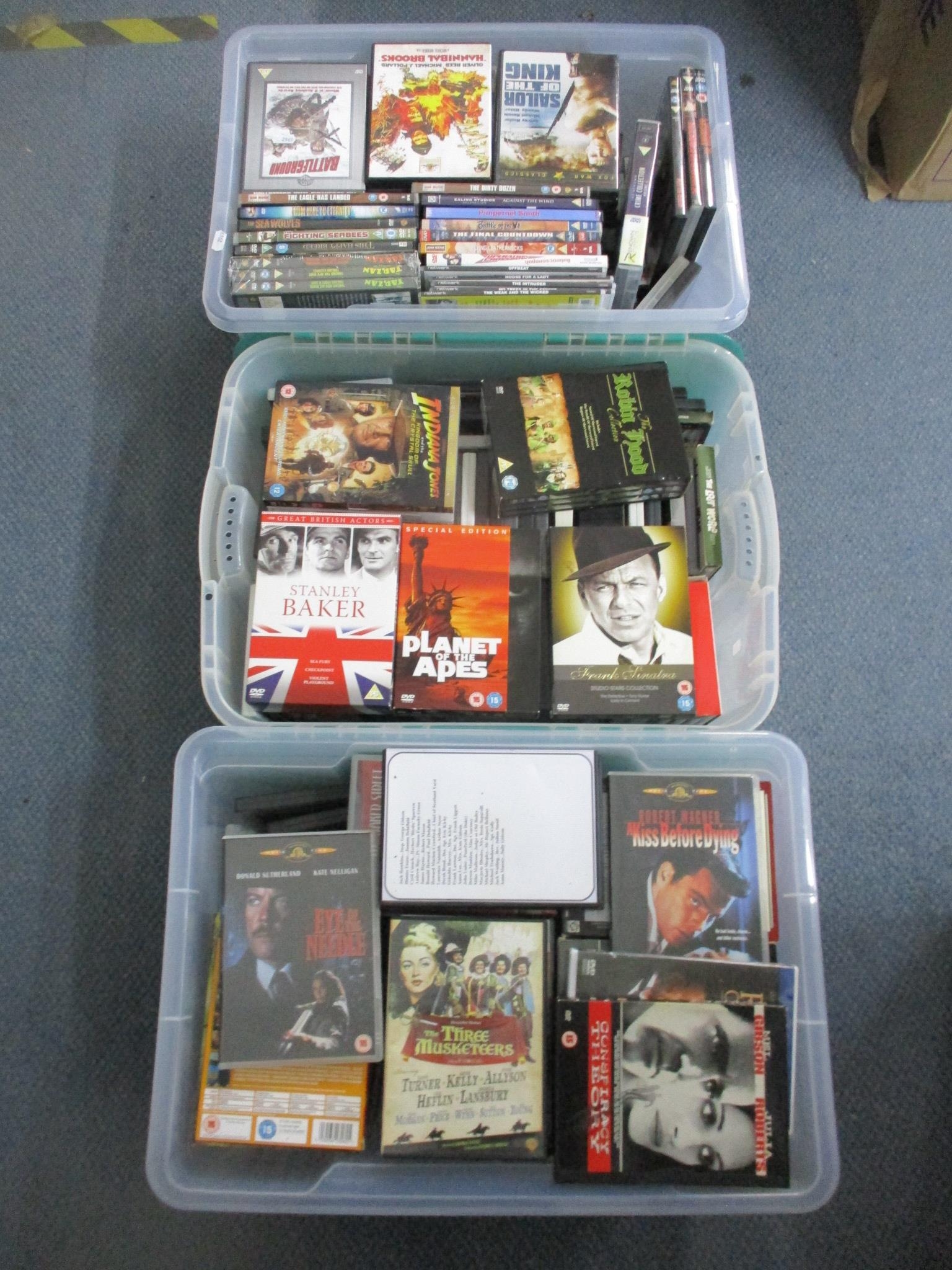 Three boxes of DVDs to include The Three Musketeers, Planet of the Apes, and Sailor of the King