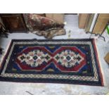 A Turkish style rug with twin medallions, 215cm x 113cm Location: