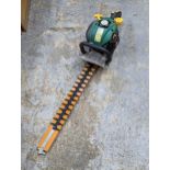 A petrol hedge trimmer Location: G