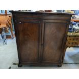 An early 19th century mahogany two door cabinet having reeded mouldings and fitted with loose