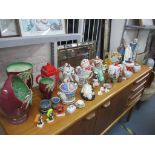 A mixed lot of ceramics to include various novelty teapots, Beswick vases and a basket, Cascades