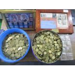 A selection of British coinage to include two tins of brass threepence pieces, an album of