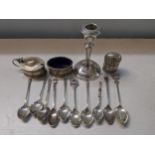 Mixed silver to include condiments, teaspoons, 135g and a silver candlestick Location: TABLE