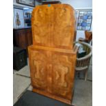 AN Art Deco walnut veneered Epstein style cocktail cabinet having four cupboard doors opening to