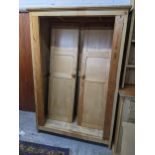 A 19th century and later pine two door wardrobe having panelled doors and block shaped feet, 190cm h