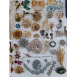 A quantity of costume and vintage brooches to include Golly and paste examples together with fashion