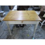 A pine kitchen table with single frieze drawer, the sides and turned legs painted white 79cm x 100cm