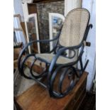 An early 20th century black lacquered bentwood rocking chair Location: