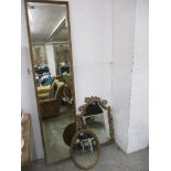 A gilt wall hanging full length cheval mirror, an ornate gilt framed wall mirror and a strut back