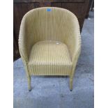 A gold coloured Lloyd Loom armchair Location: