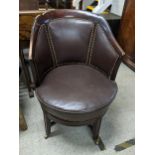 An early 20th century mahogany framed brown leather upholstered rotating desk chair Location: