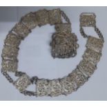 A Victorian pierced and ornate silver belt, 169g, with embossed swirls, flora and a cherub to the