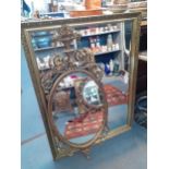 A large gold framed mirror together with a reproduction mirror with neo classical scrolls