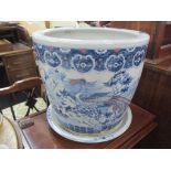 A 20th century Chinese blue and white planter decorated with scenes of Dragons, raised on a circular