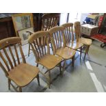 A set of six Windsor kitchen chairs including a high back armchair, slat backs, ring turned legs