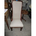 Victorian mahogany upholstered nursing chair with carved decoration and French style cabriole legs