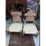 A pair of similar vintage Indian carved wooden chairs with woven string seats on turned legs