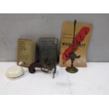 Collectables to include a vintage flint lock style lighter, a Roman style oil lamp, a bell, pocket