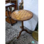 A Victorian walnut games table on a tripod base 70cm h x 44cm dia. Location: