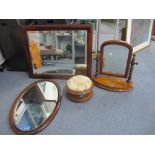 A cushion moulded mahogany framed rectangular wall mirror, an inlaid oval framed wall mirror, a