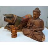 A carved wooden rocking pig, a carved wooden Buddha, and a Chinese figure Location: