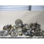 A selection of white metal and silver plated items to include a wine coaster, mixed cutlery,