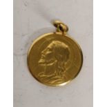 A yellow metal religious Jesus pendant, 2.6g. Location: