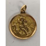 A yellow metal religious pendant, 2.8g. Location: