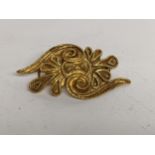 A Greek gold asymmetrical brooch with scrolls, tested as 18ct, 11.7g Location: