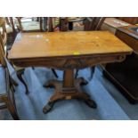 An early 19th century mahogany fold over card table having a green baize, quadrafoil base and on