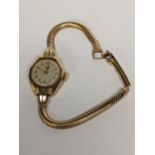 A mid 20th century 9ct gold J.W Benson ladies wristwatch on a yellow metal bracelet, 14.7g Location: