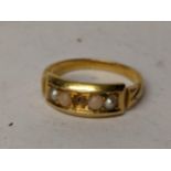 A yellow metal ring inset with seed peals, central stone missing. 3.8g Location: