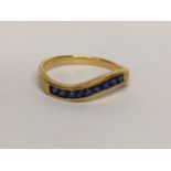 An 18ct ring inset with nine sapphires, 2.5g Location: