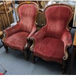 A pair of Victorian mahogany spoon back salon armchairs having scroll shaped arms and turned legs