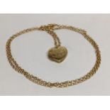 A 9ct gold chain link necklace together with a yellow metal heart shaped locket, 4.4g Location: