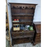 An early 20th century oak dresser with two draws, over a shelf. Location: