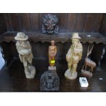 A selection of carved wooden items to include two oak lion heads, Asian carved figures and others