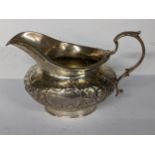 A Victorian silver cream jug with embossed floral and C-scrolls hallmarked London 1843, 205.7g