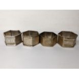 A set of three early 20th century napkin rings and one other, all with initials 101g Location: