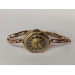 An early 20th century 9ct gold ladies manual wind wristwatch on a 9ct gold expanding bracelet