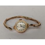 An early 20th century 9ct gold ladies manual wind wristwatch on a 9ct gold expanding bracelet, 13.1g