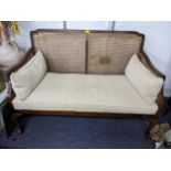 An early 20th century mahogany two seater Berger sofa having sausage and pea moulding and on ball