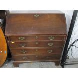 A Georgian mahogany bureau of one short and three long graduated drawers, fall flap revealing a