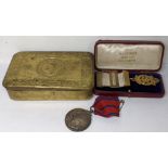 A WWI Christmas tin containing a Metropolitan Police Coronation medal, and a silver gilt medal